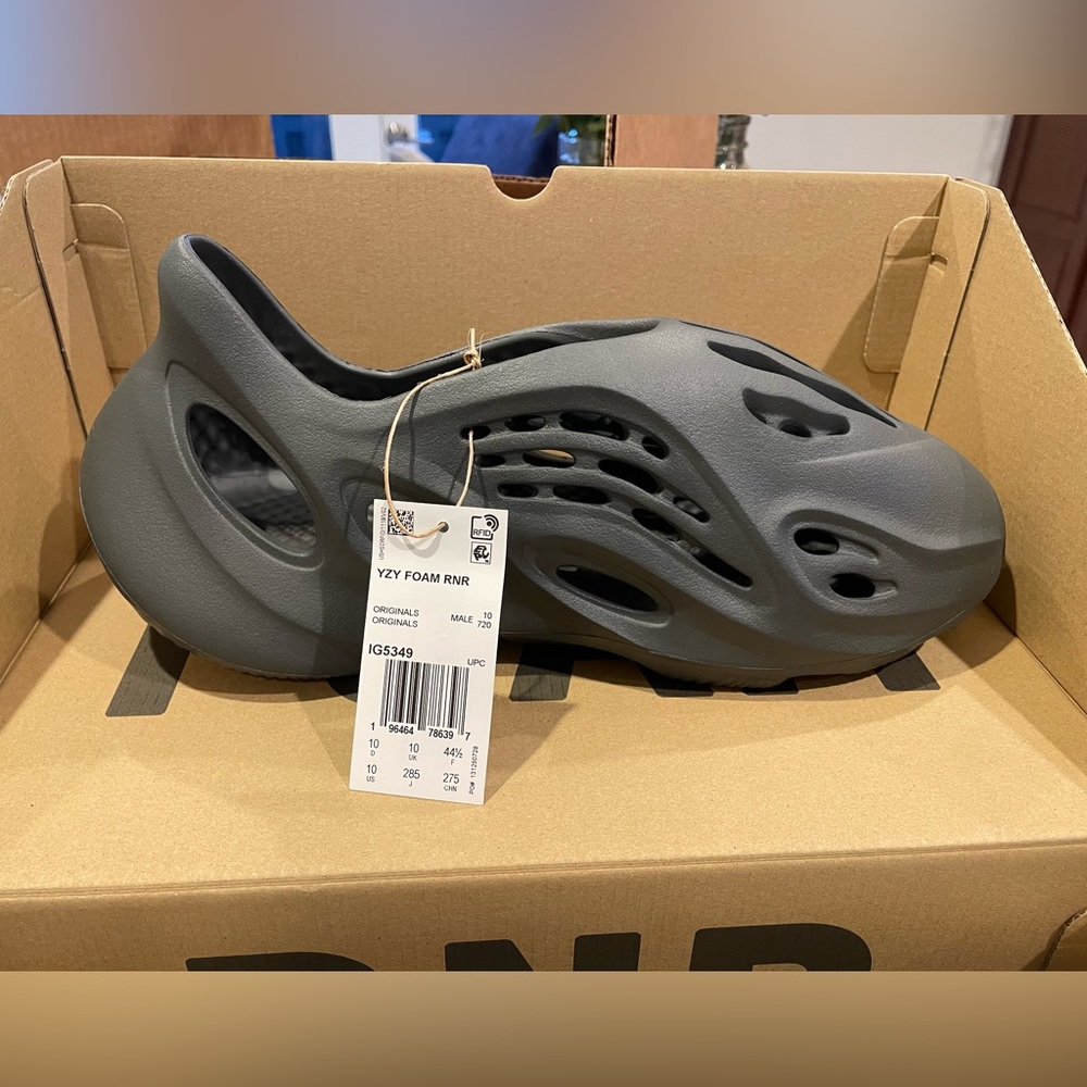 Yeezy Foam RNR. Size 10. Brand New. Carbon Color. Includes rare pin.
